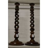 A pair of wooden open barley twist candle sticks.