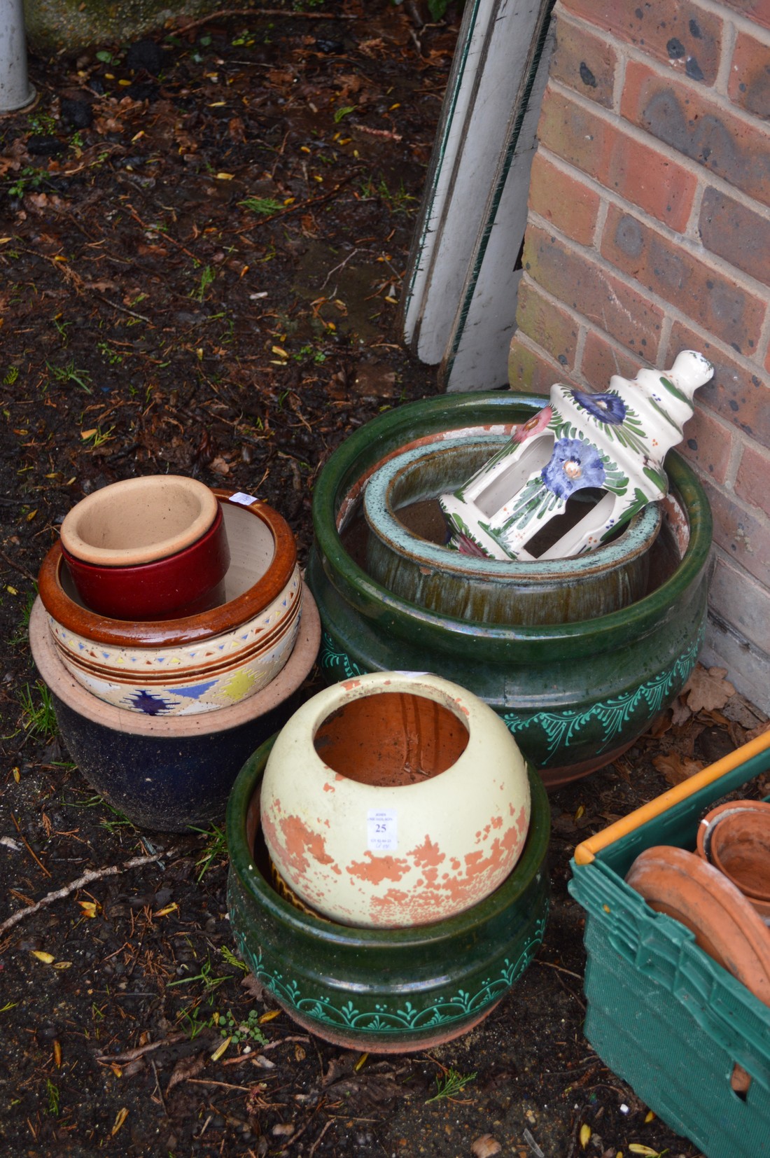 A small group of glazed plant pots.