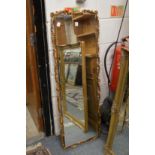 A dressing mirror with decorative gilt frame.