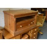 A pine single drawer TV stand.