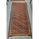A Persian rug, dark blue and red ground with stylised decoration 198cm x 83cm.