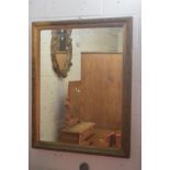 A large gilt framed mirror.