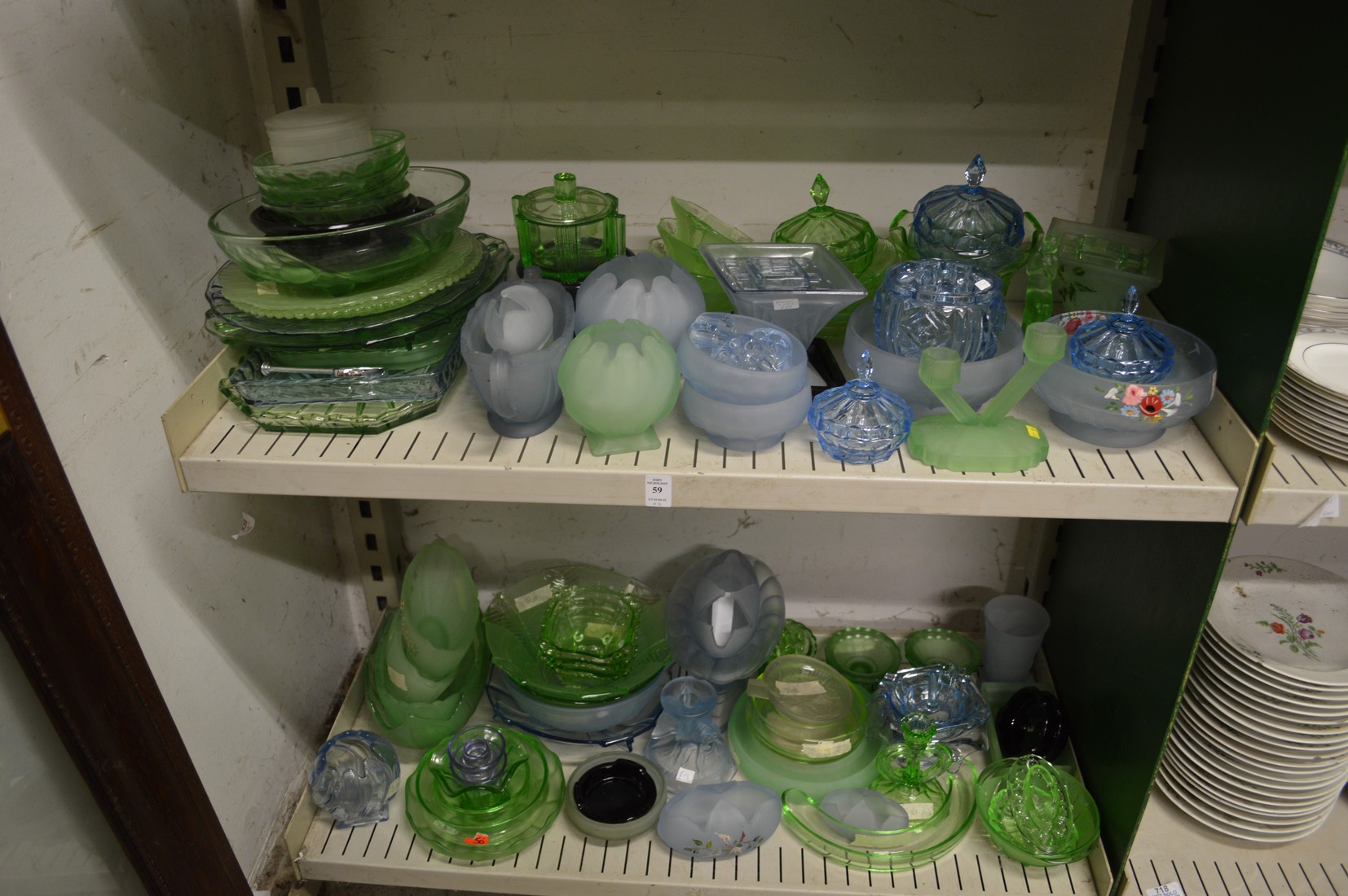 A large quantity of frosted blue and green glass vases, flower jars, trays, dishes, bowls etc.