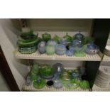A large quantity of frosted blue and green glass vases, flower jars, trays, dishes, bowls etc.