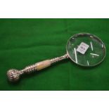 A decorative magnifying glass.