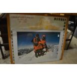 A photographic colour print depicting two mountaineers, signed Chris Bonnington (?) together with