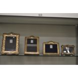 Four silver photograph frames.