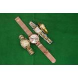 A Tommy Hilfiger wrist watch and three others.