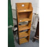 An oak narrow bookcase.