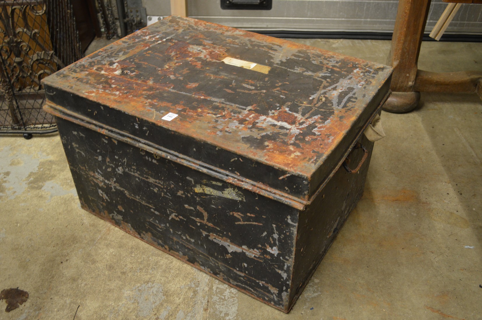 A tin trunk containing various old Persian and other carpets etc (sold as seen).