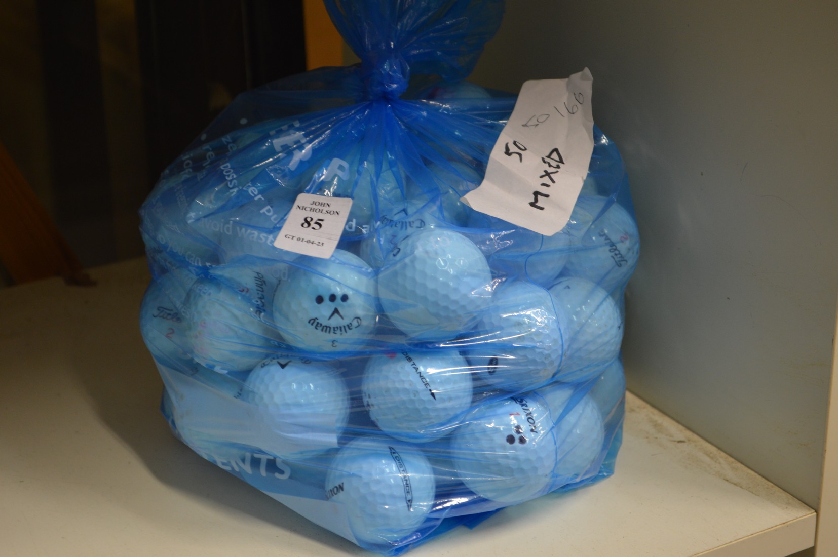 A bag fifty mixed golf balls.