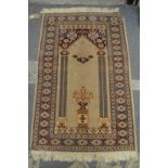 A small Persian style prayer rug 110cm x 74cm.