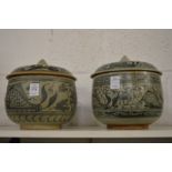 A matched pair of Asian blue and white porcelain jars and covers painted with fish and flora.