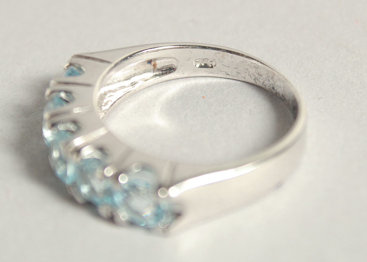 A SILVER BLUE TOPAZ HALF ETERNITY RING. - Image 3 of 3