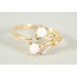 A 9CT. GOLD OPAL AND DIAMOND CROSSOVER RING.