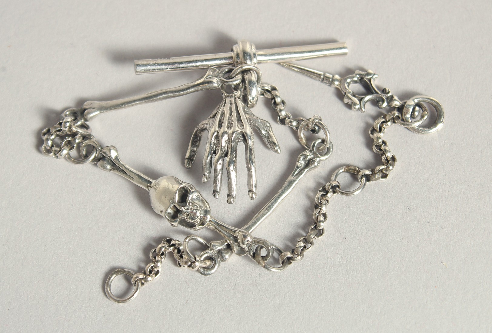 A SILVER SKULL WATCH CHAIN.