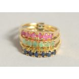 A SILVER AND 18 CT GOLD PLATED SAPPHIRE RUBY AND EMERALD STACK RING.