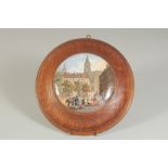 A PORCELAIN POT LID, A FRENCH STREET SCENE, 4.5ins diameter, framed.