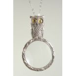 A SILVER OWL MAGNIFYING GLASS ON A CHAIN.