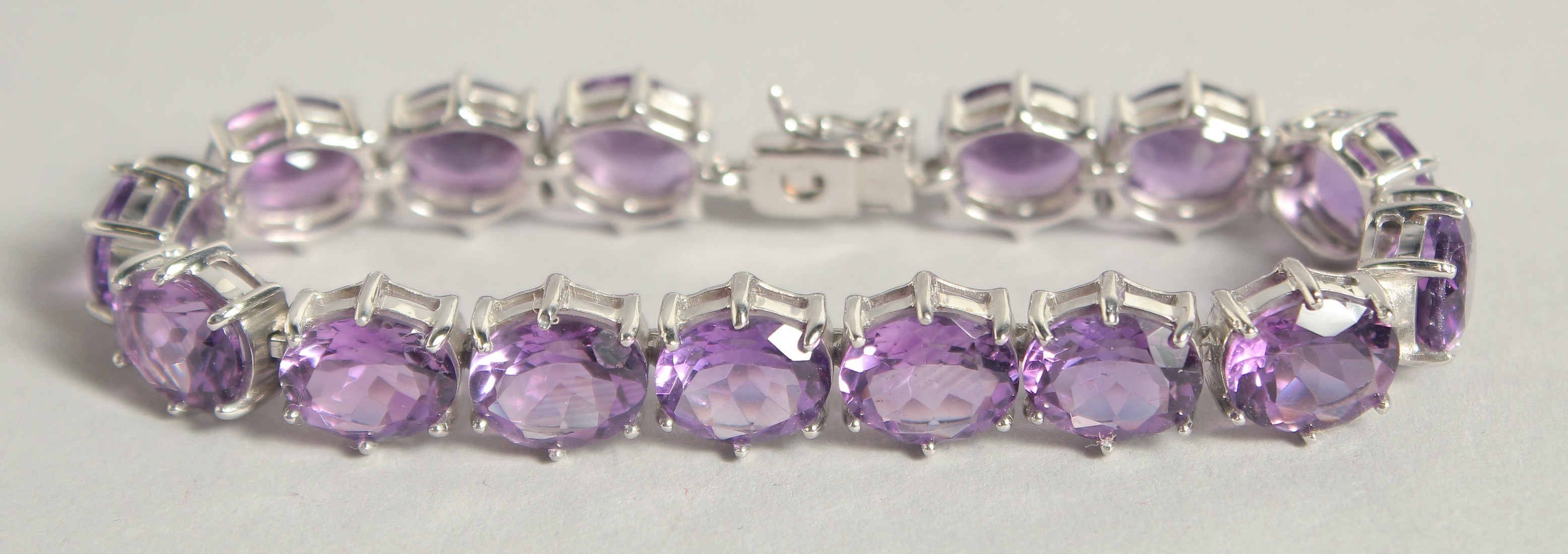 A SILVER BRACELET WITH FIFTEEN REAL AMETHYSTS.