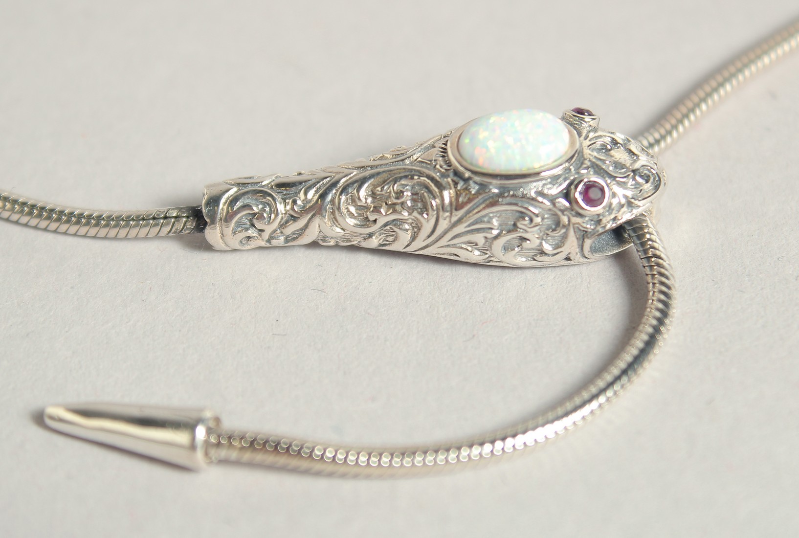 A SILVER OPAL AND RUBY EYE SNAKE BRACELET.