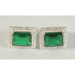 A PAIR OF SILVER AND FAUX EMERALD SQUARE SET EARRINGS.