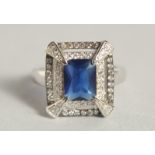 A SILVER DECO STYLE RING WITH CUBIC ZIRCONIA AND SAPPHIRE.
