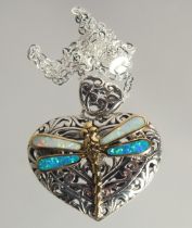 A SILVER HEART SHAPED PENDANT WITH DRAGONFLY ON A CHAIN.