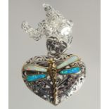 A SILVER HEART SHAPED PENDANT WITH DRAGONFLY ON A CHAIN.