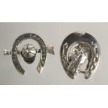 TWO SILVER HORSESHOE BROOCHES.