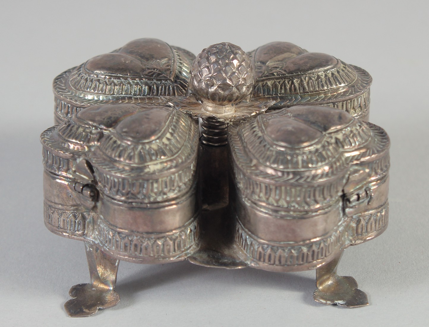 A 19TH CENTURY INDIAN SILVER SPICE BOX, with four compartments, 10cm wide.