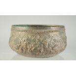 AN INDIAN EMBOSSED AND CHASED METAL BOWL, 16cm diameter.