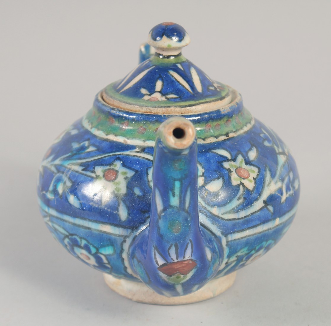 A PALISTINIAN GLAZED POTTERY TEAPOT, with foliate decoration, 19cm spout to handle. - Image 2 of 7