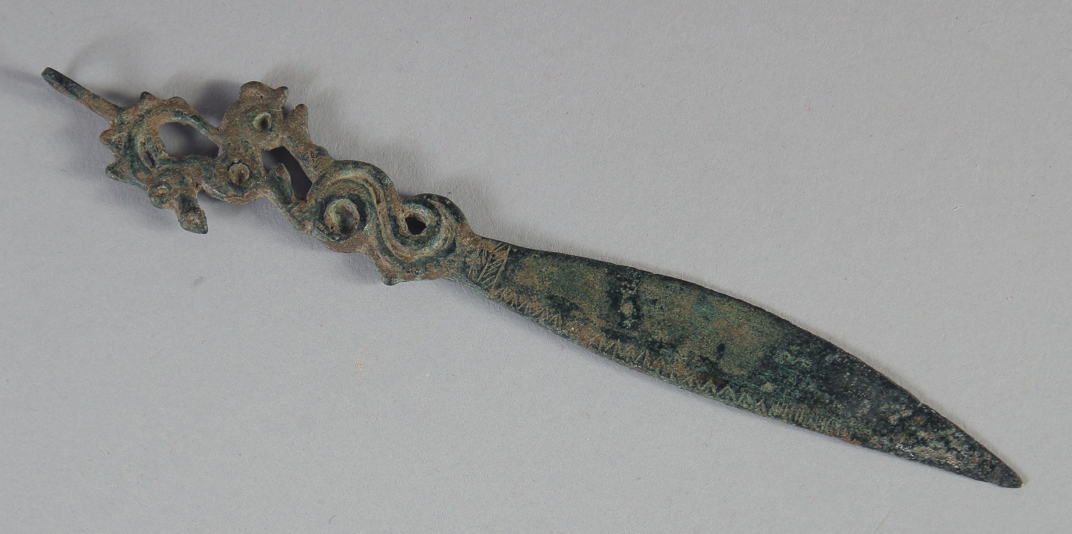 A RARE ANCIENT PERSIAN SASSANIAN BRONZE BLADE, the finial in the form of a ram, 15cm long.