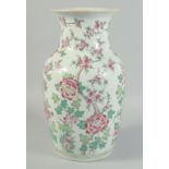 A CHINESE FAMILLE ROSE PORCELAIN VASE, painted with native flora, 36.5cm high.