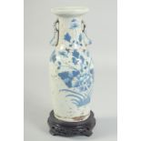 A 19TH CENTURY QING DYNASTY CHINESE BLUE AND WHITE TWIN HANDLE VASE, with hardwood stand, vase 23.