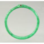 A JADEITE SNAKE-FORM BRACELET with inset ruby eyes, 7cm diameter.