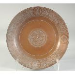 AN ENGRAVED COPPER DISH, 34cm diameter.