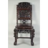 A 19TH CENTURY CHINESE CARVED HARDWOOD CHAIR, the back rest carved and pierced with dragons and