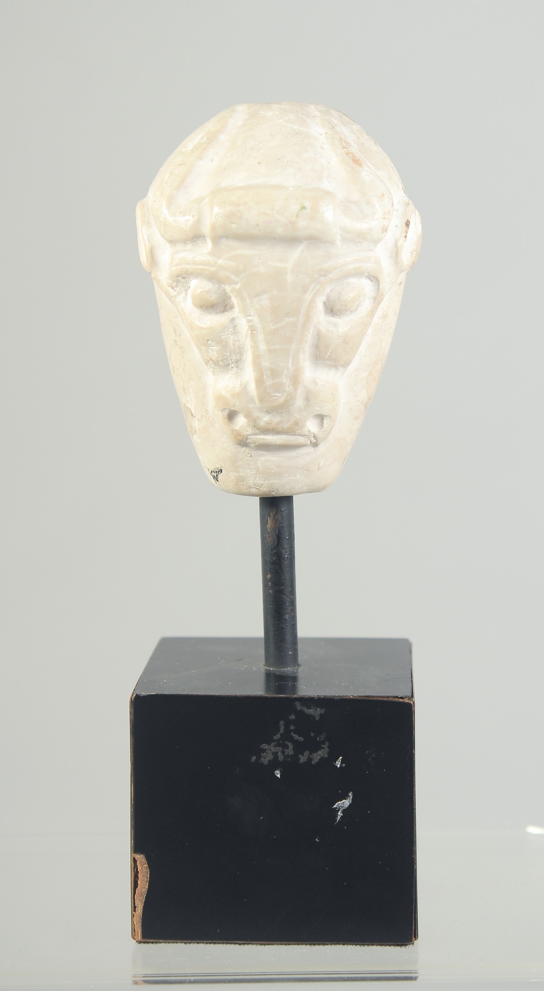 A RARE MESOPOTAMIA MASE HEAD with carved double-sided bull head, 4000 bc, raised on a purpose-made
