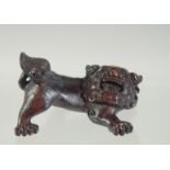 A CARVED WOODEN NETSUKE of a lion dog, 6cm widest point.