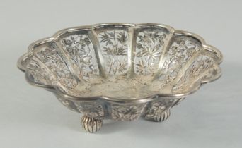 A SMALL CHINESE ENGRAVED AND PIERCED SILVER PETAL FORM DISH, on three ball feet, stamped to base,