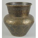 AN ISLAMIC ENGRAVED BRASS VASE, with openwork collar and panels of calligraphy, 29.5cm high.