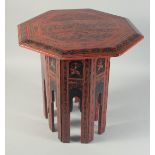 AN ORIENTAL RED AND BLACK LACQUERED WOOD TABLE.