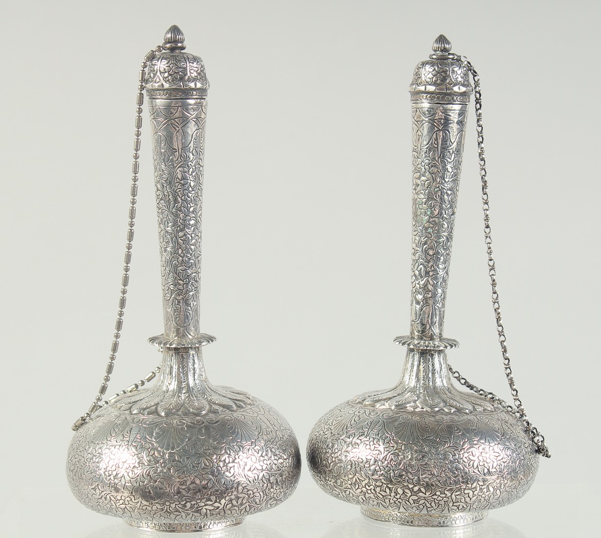 A FINE PAIR OF EARLY 19TH CENTURY NORTH INDIAN ENGRAVED SILVER LIDDED BOTTLES, 15.5cm high.