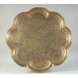 A LARGE PERSIAN ISFAHAN SIGNED ENGRAVED PETAL-FORM BRASS TRAY, inscribed and dated, engraved with