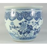 A LARGE 19TH CENTURY CHINESE BLUE AND WHITE PORCELAIN JARDINIERE, painted with birds and flora, (