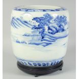 A CHINESE BLUE AND WHITE PORCELAIN JARDINIERE, on a fitted hardwood stand, 28.5cm high overall.