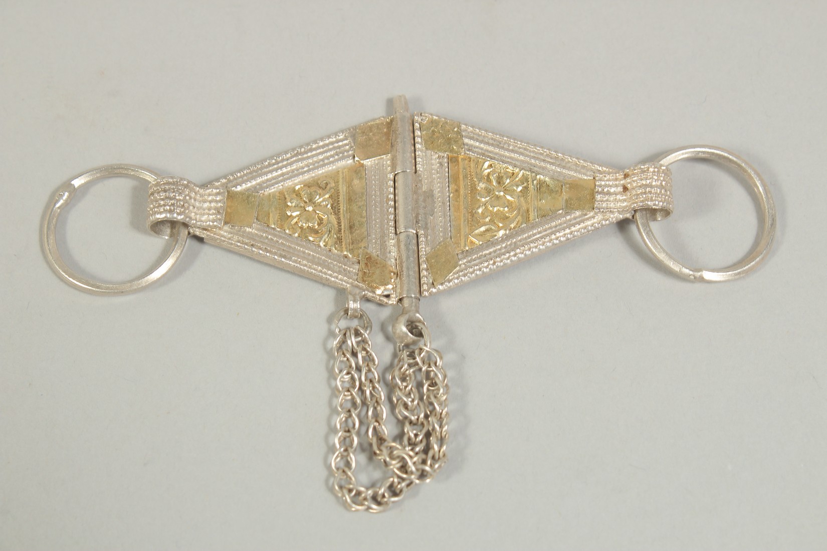 AN OMANI GOLD OVERLAID BUCKLE.