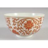 A CHINESE RED AND WHITE PORCELAIN BOWL, with floral motifs and gilt highlights, the base with four-